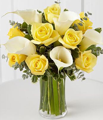 yellow roses and white calas