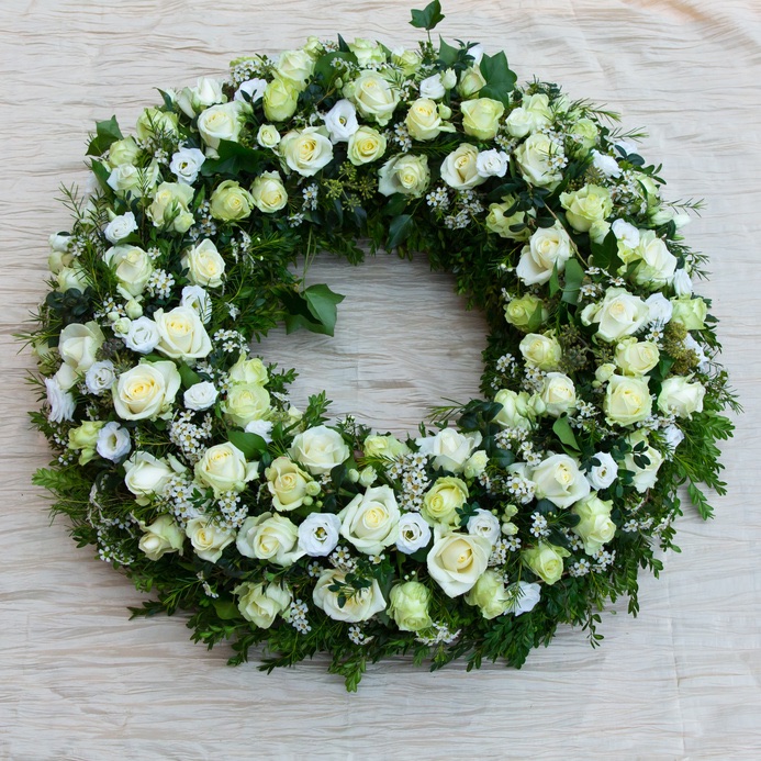funeral wreath with roses and mixed white flowers
