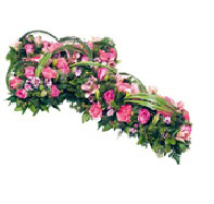 funeral cross of pink roses lilies and orchids
